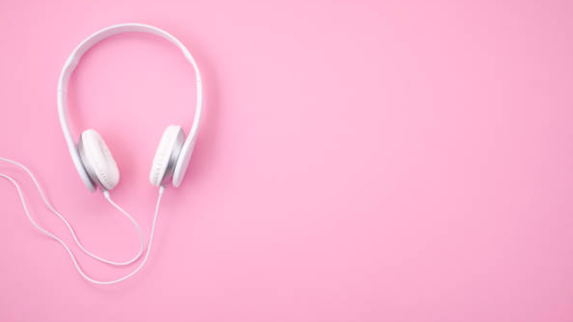 pair of black headphones against a light blue-green backdrop