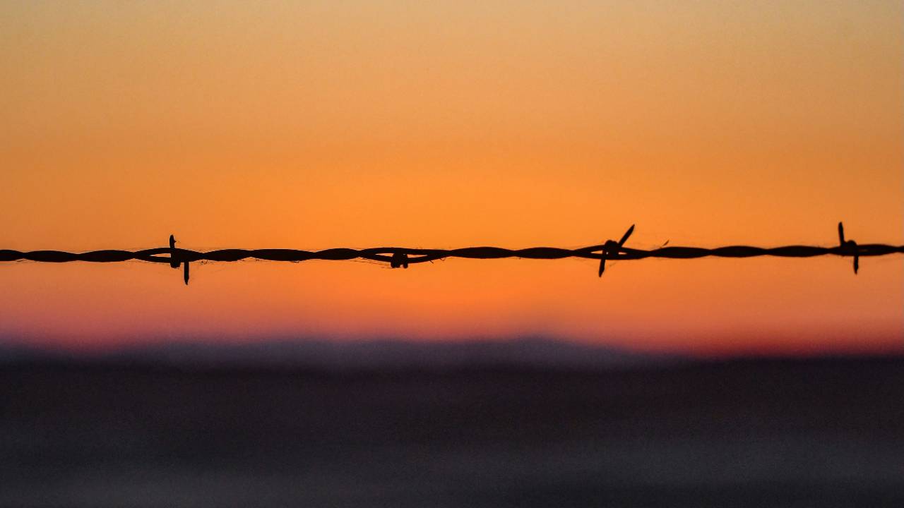Photo by <a href="https://unsplash.com/@elisastonephotography?utm_source=unsplash&utm_medium=referral&utm_content=creditCopyText">Elisa Stone</a> on <a href="https://unsplash.com/photos/barbed-wire-fence-silhouetted-against-a-vibrant-sunset-sky-3sTawOCVwTQ?utm_source=unsplash&utm_medium=referral&utm_content=creditCopyText">Unsplash</a>