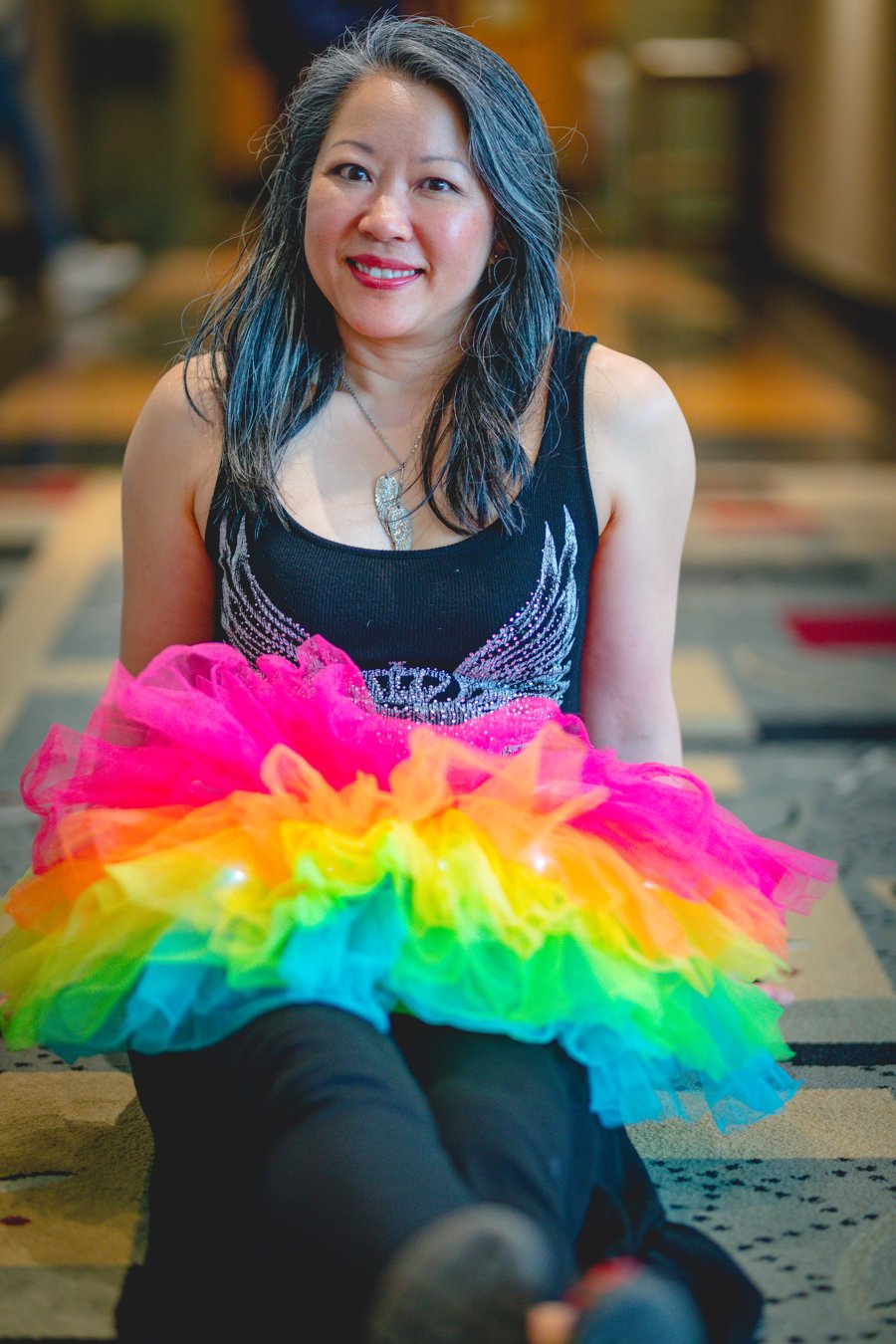 Dr. Karen Kan smiling, wearing a rainbow tutu