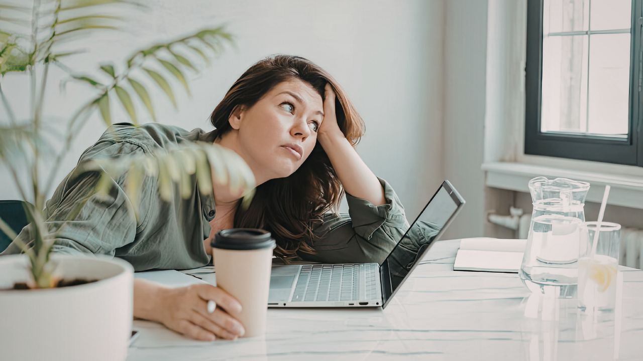 Woman in front of a laptop worrying about life