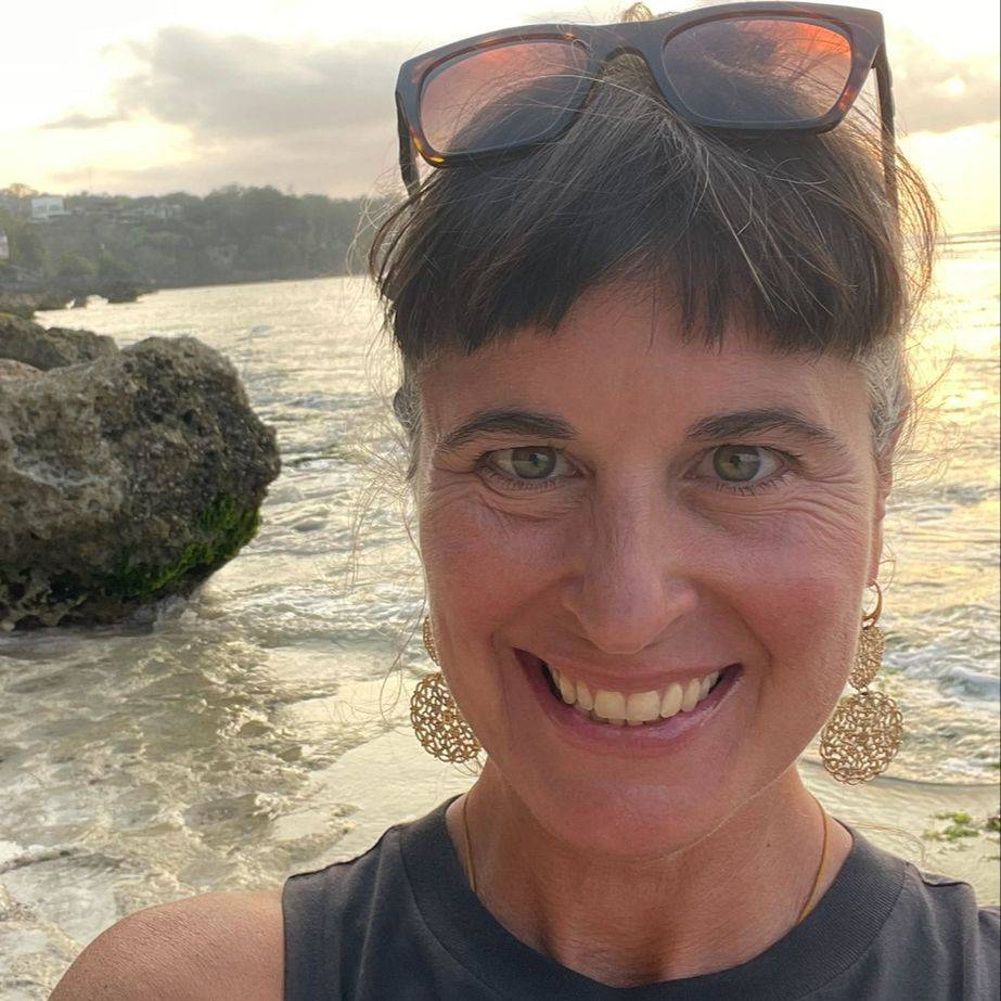 Dr. Tia Trivisonno smiling by the water, representing confidence, wellness, self-care, and vibrant healthy aging through the Aging Into Vitality® program.