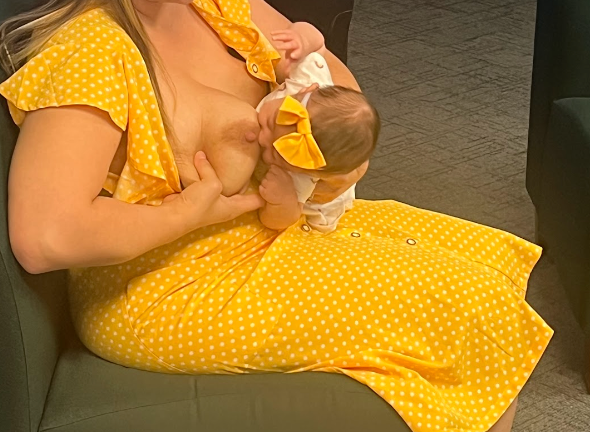 Baby positioned close to the breast while preparing to latch