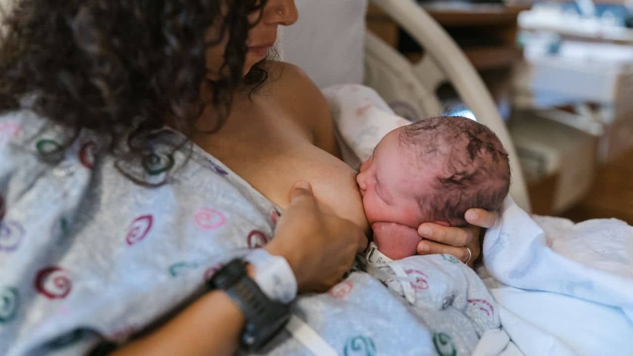 New mother making a mistake while latching baby