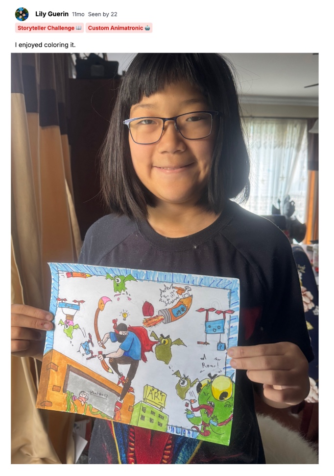 Camper holding her finished epic comic project
