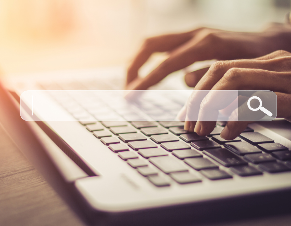 hands typing on keyboard with a search box over top of it