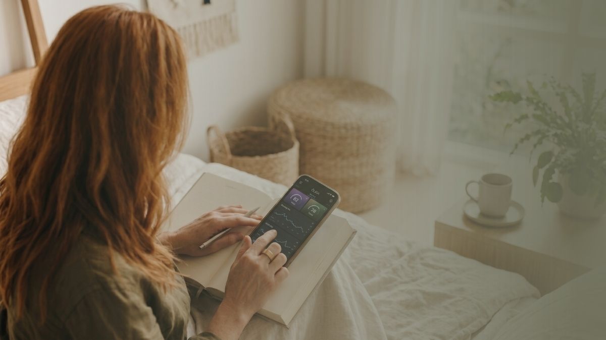 woman looking at her Oura ring data