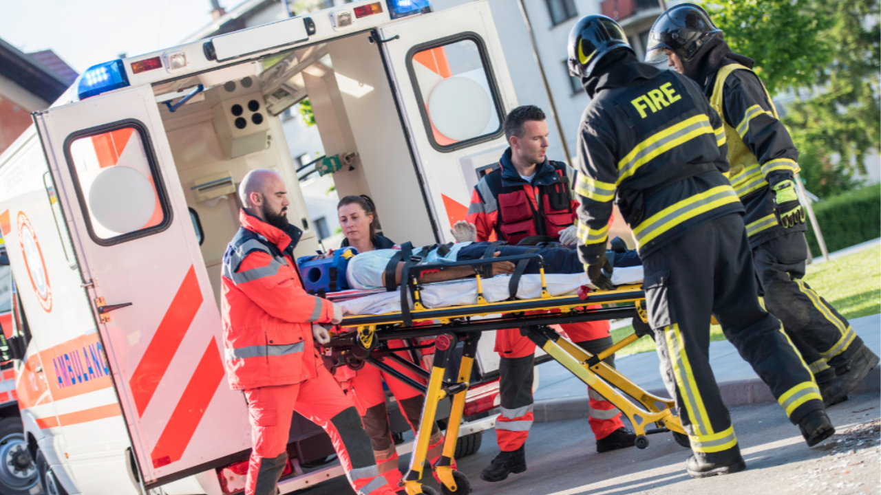 Firefighters assisting paramedics during an emergency response showing teamwork, courage, and the value of essential frontline workers