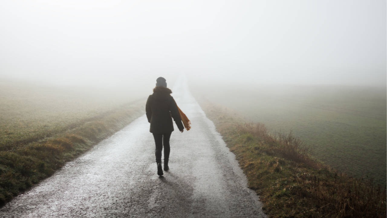 A lone person walking along a peaceful path, symbolising reflection and personal growth