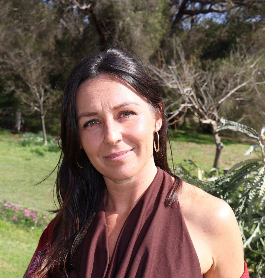 Rhiannon Heins in a red shawl in her garden