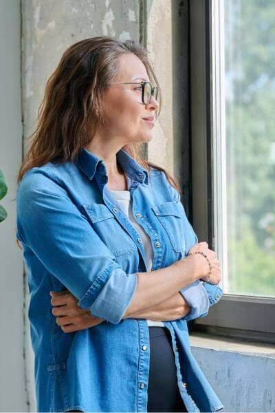 Woman with FND looking out of the windorw