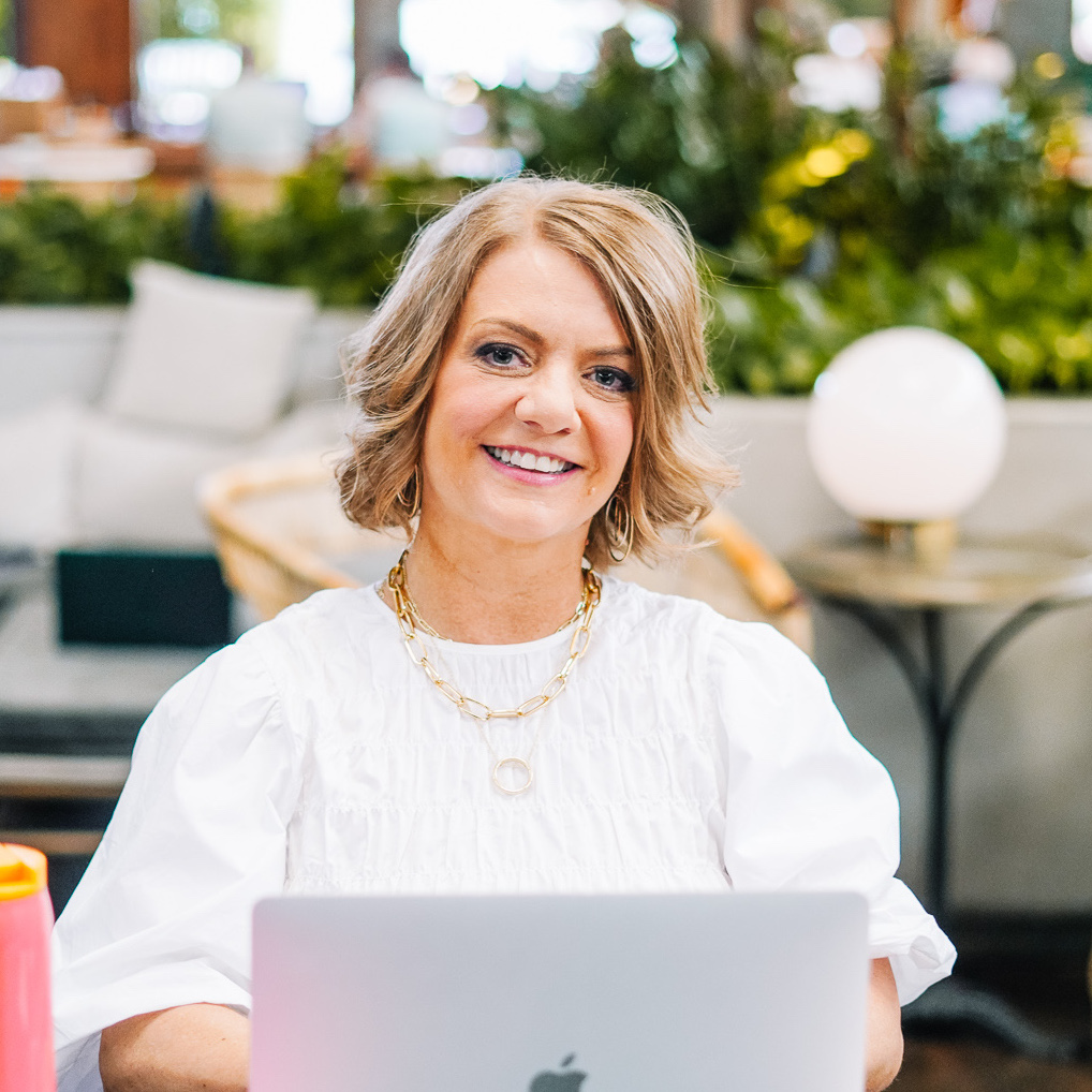 Krista Young smiling with laptop open