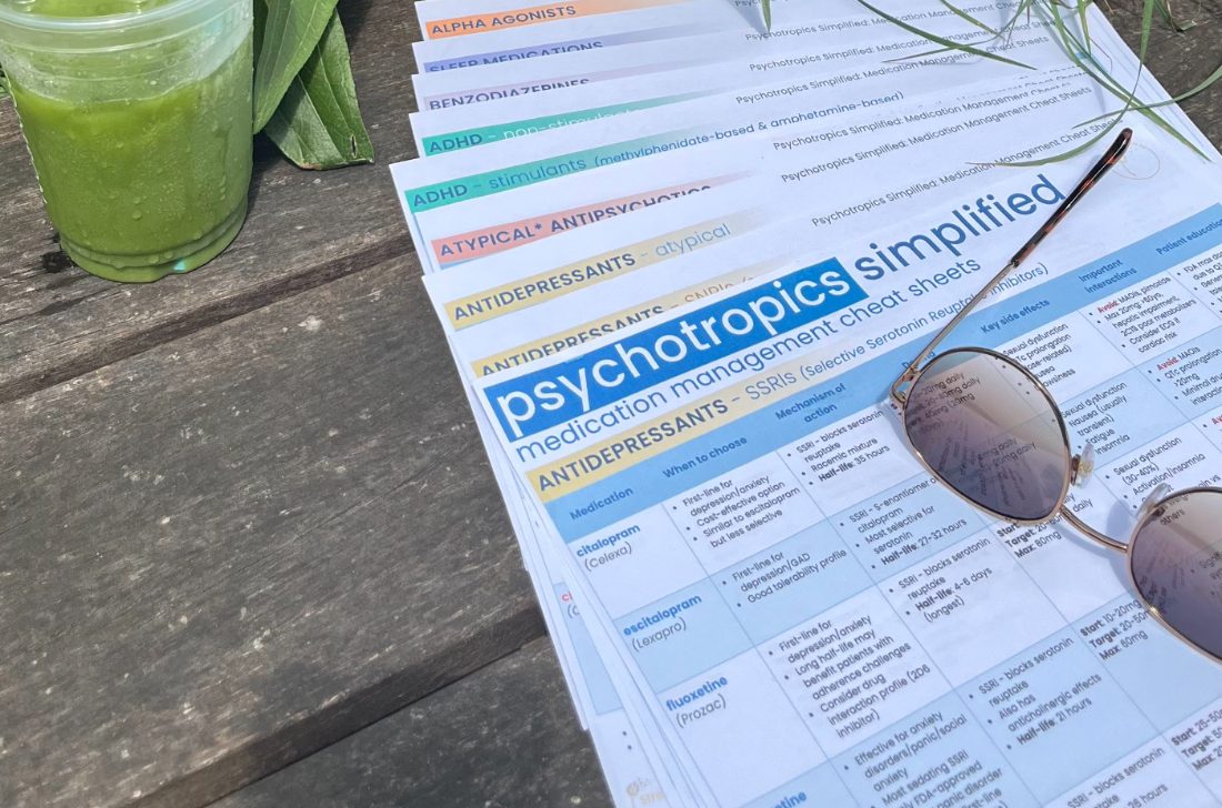 The 12 cheat sheets printed and fanned out on an outdoor table
