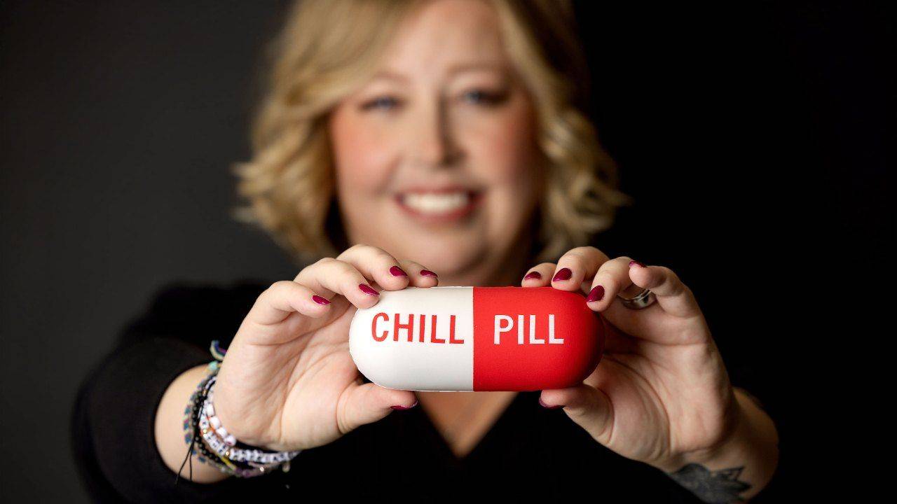 Therapist Becca Gerlach smiling and holding up a large red and white pill that reads Chill Pill. Many people picture a therapy intensive in Michigan as an exhausting marathon, and it turns out to move at your nervous system's pace, with breaks and even laughter. Becca offers therapy intensives in Plymouth, Michigan, and you can start with a free consultation.