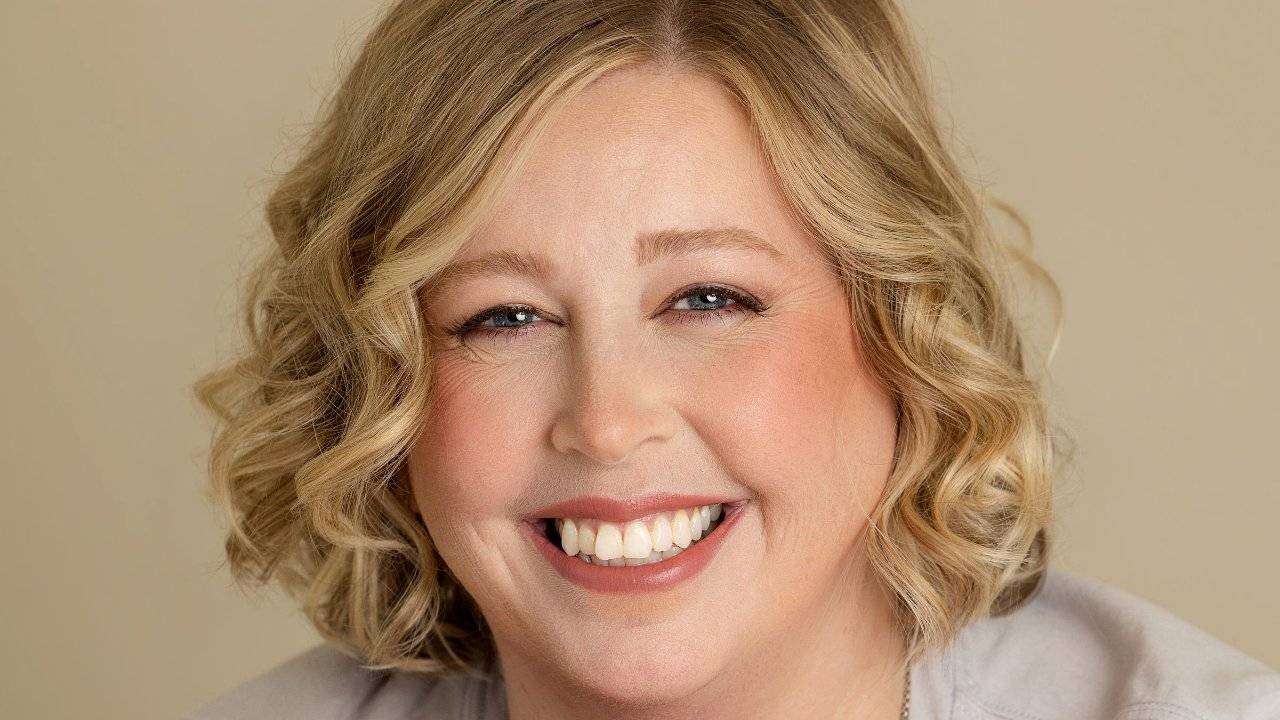 Becca Gerlach smiling with hands folded, clinical supervision and EMDR consultation, Plymouth, Michigan therapist