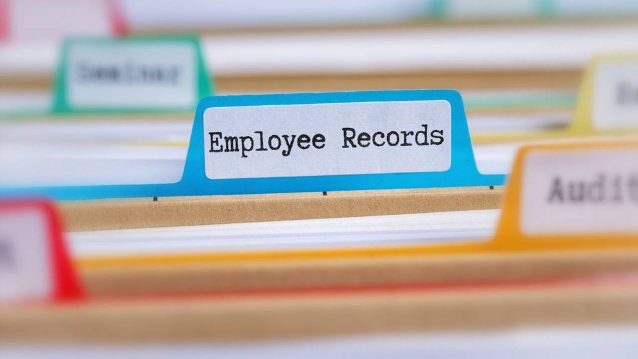 File folders with a tab labeled employee records