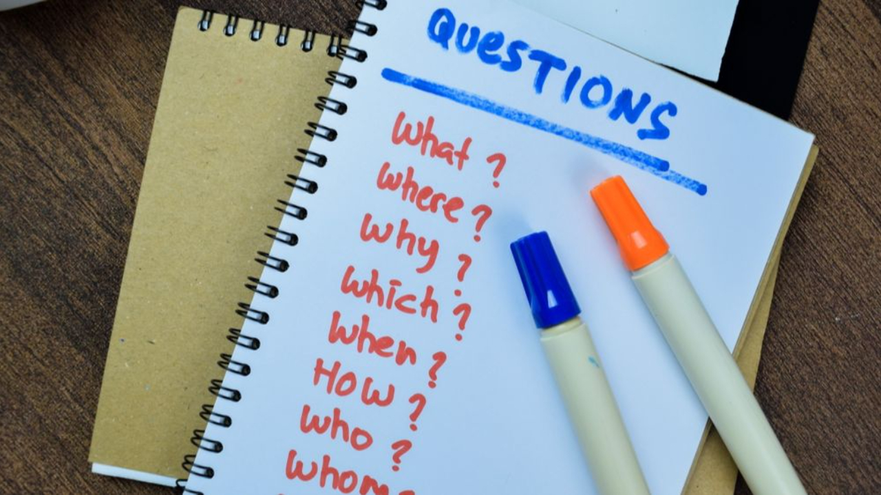 List of questions with markers on paper