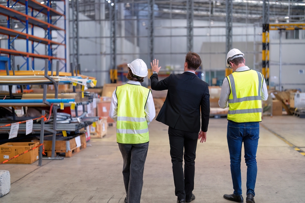 Manager visiting staff in storage warehouse.