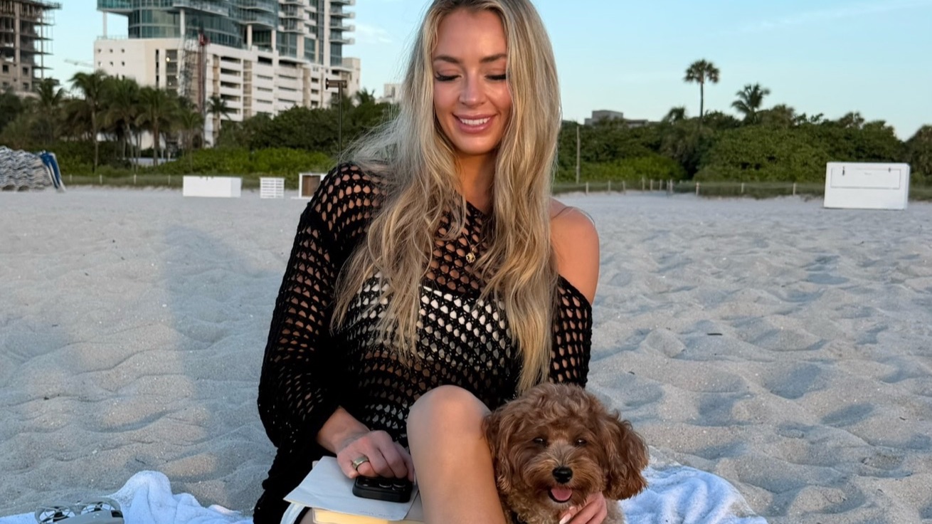 Brittany Arnason at the beach with a very cute dog.