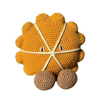 Patty Gourd, a round mustard crochet gourd with feet