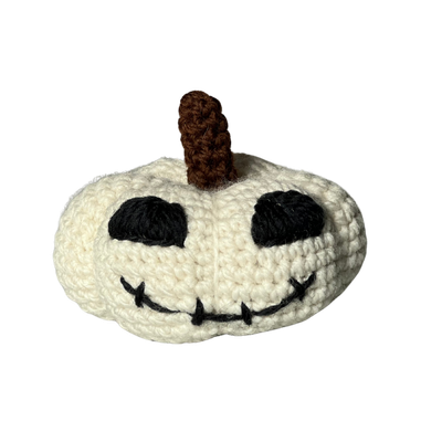 Skelly Pumpkin, a cream crochet pumpkin with a smiley face
