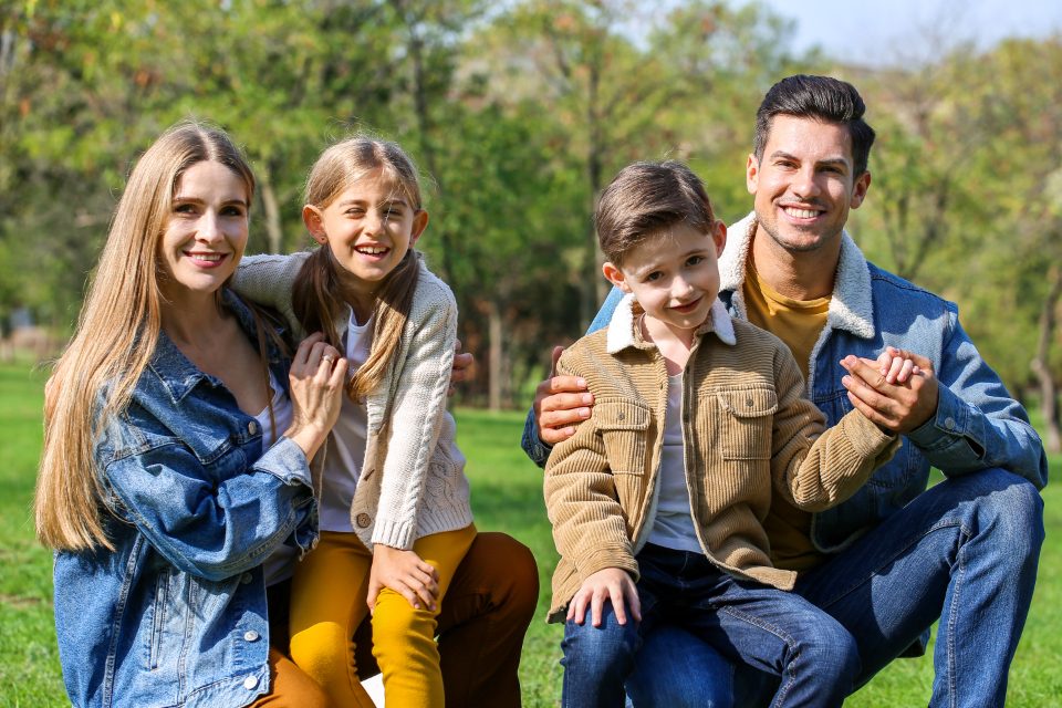 A mother, father, daughter and son together outdoors