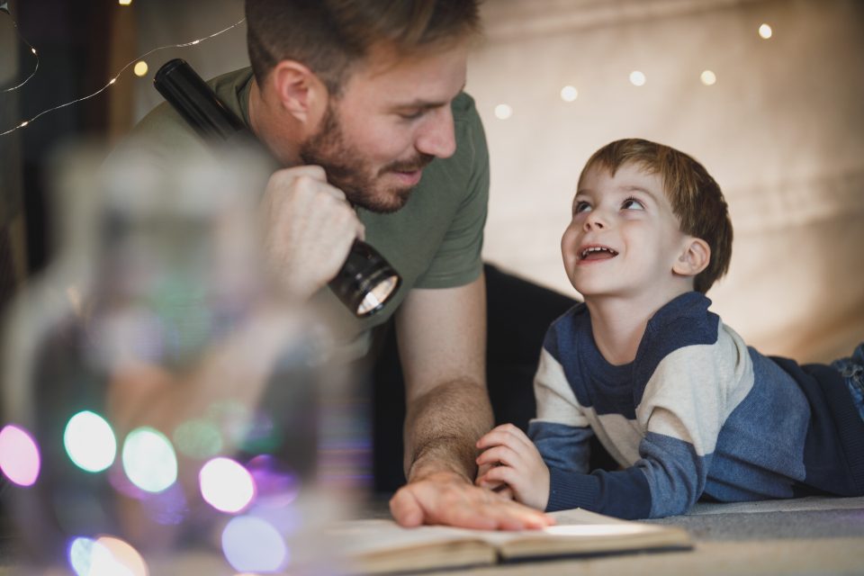 A father and son reading together