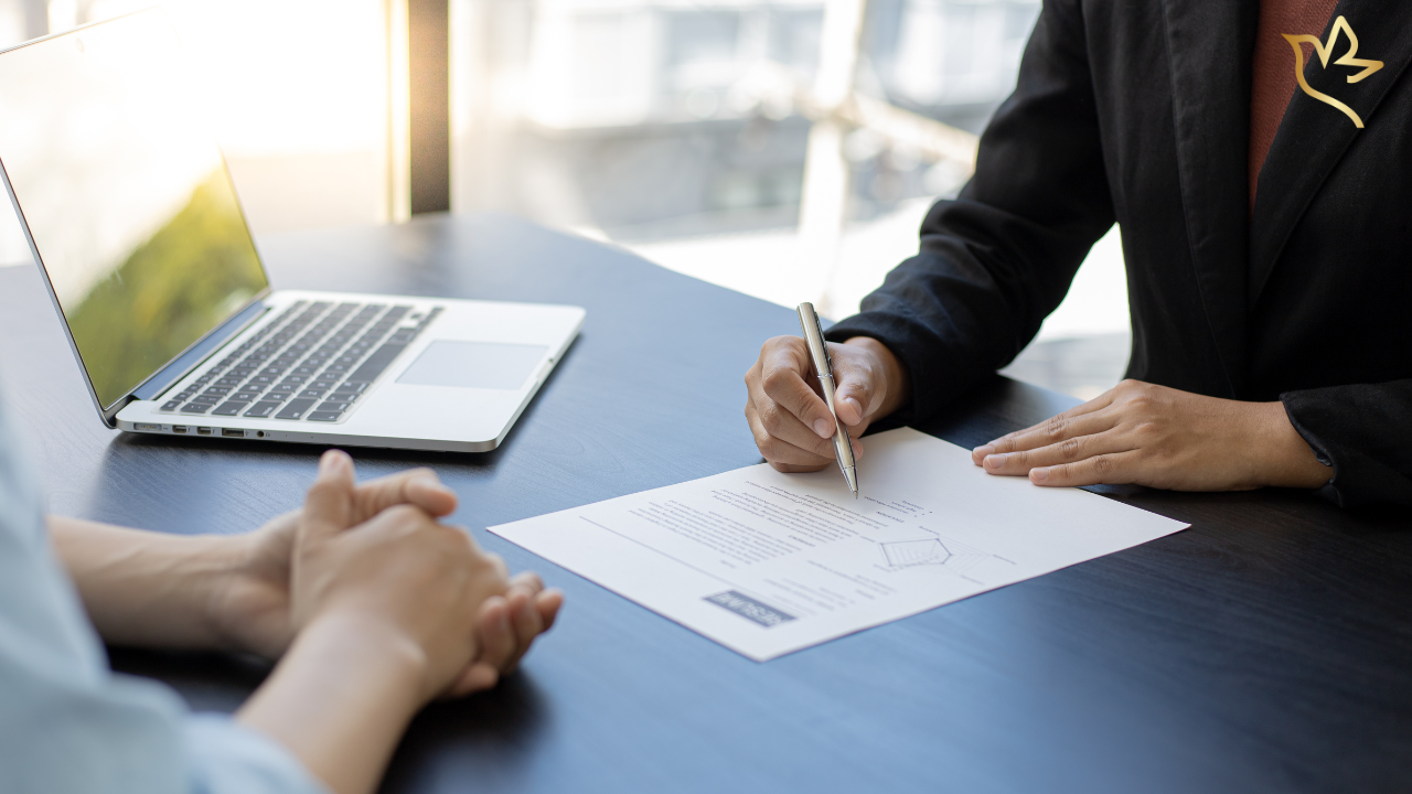 Person meeting with a benefits representative to review paperwork for employer or union death benefits after the loss of a loved one.