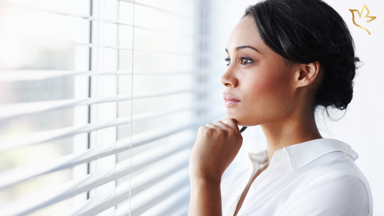 Woman thoughtfully considering how much to ask for in an online funeral fundraiser to help cover funeral and memorial expenses.