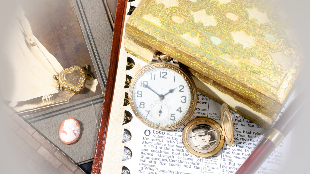 Vintage memorial keepsakes including an antique pocket watch, family photograph, heirloom jewelry, and Bible representing remembrance, family history, and preserving cherished memories after the loss of a loved one.