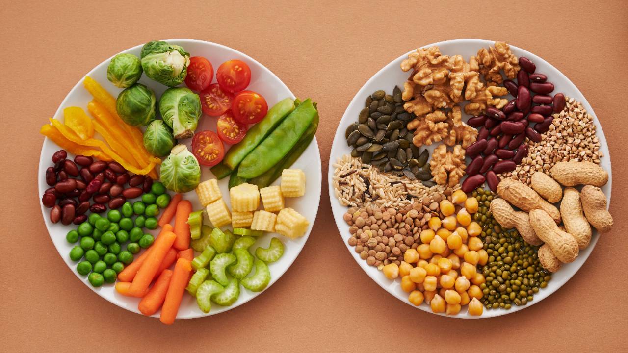 Two plates side by side full of grains, beans, fruit and nuts.