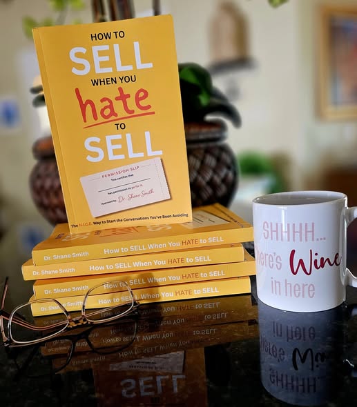 A stack of How to Sell When You Hate to Sell books on a table