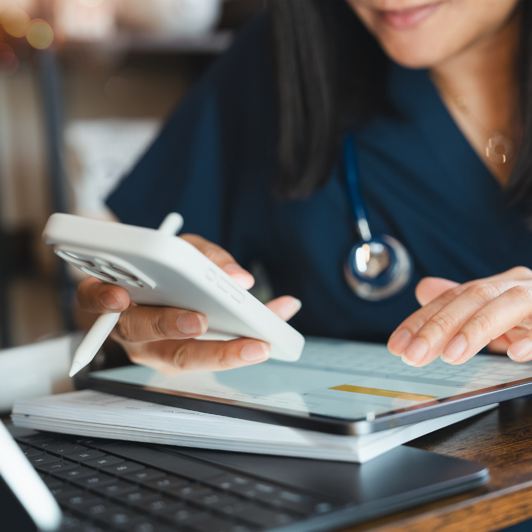 medical professional using tablet and mobile device