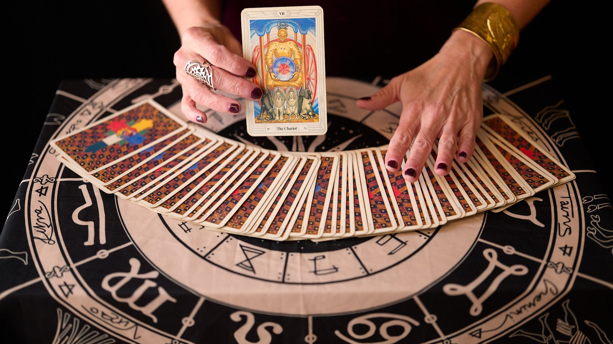 Tarot reader laying out a card spread for a corporate event in the Bay Area