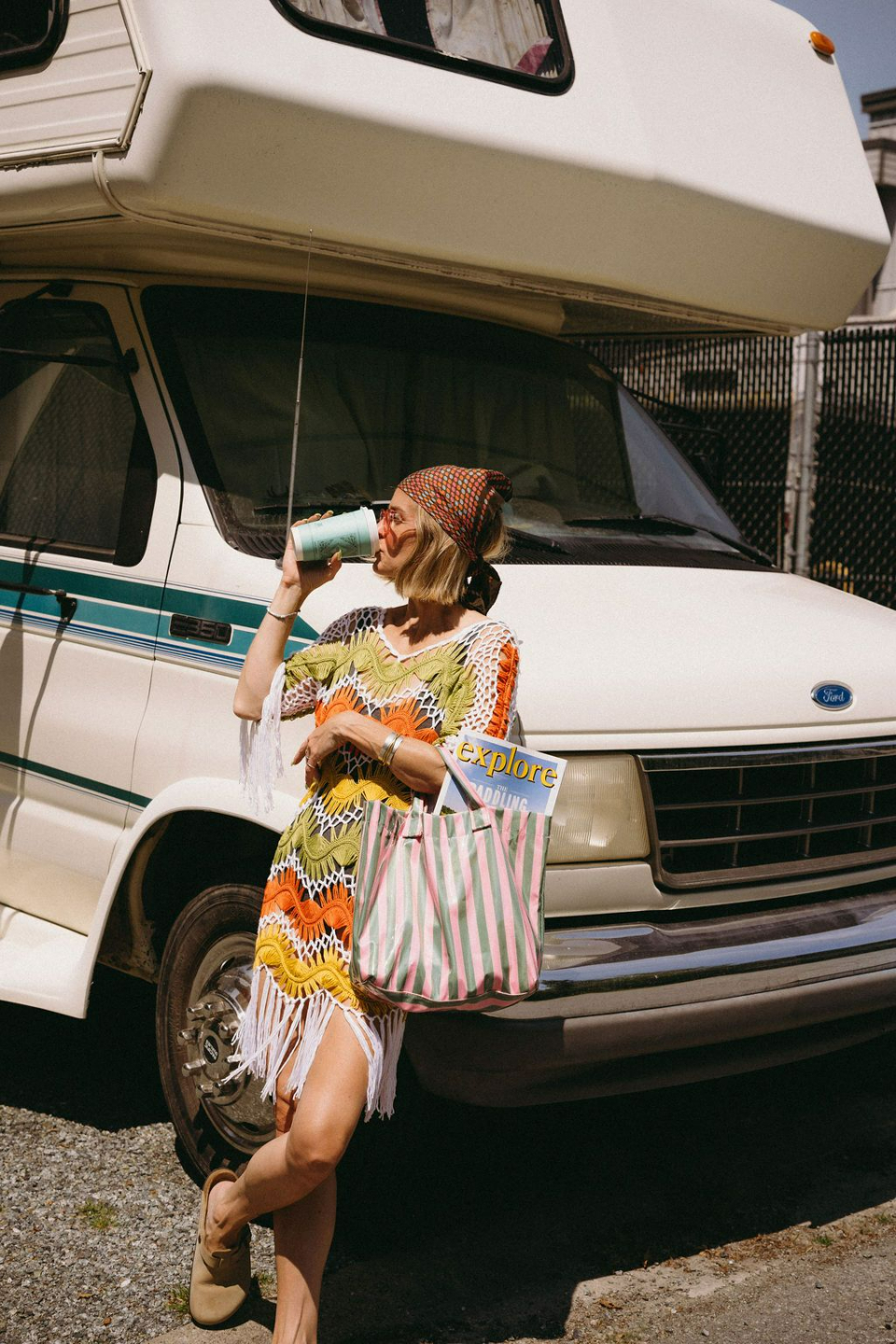 PLACEHOLDER — Photo: leaning on white van, drinking from can, striped bag