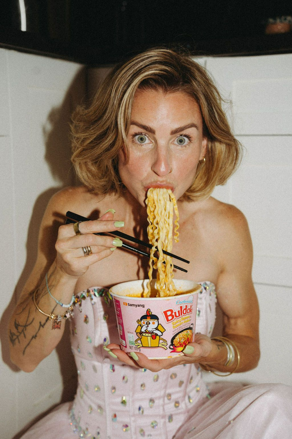 PLACEHOLDER — Photo: Robyn eating noodles, wide eyes