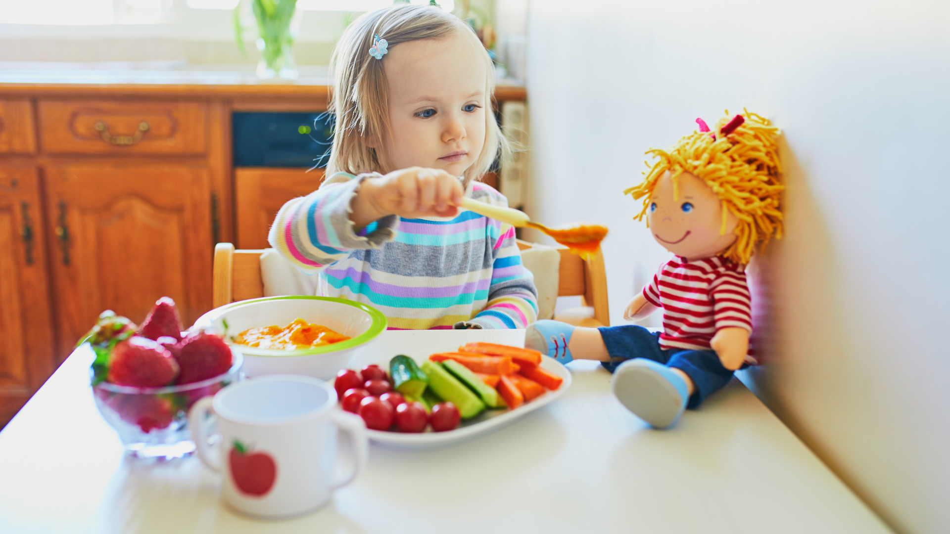 Pediatric occupational therapist supporting a child during a feeding therapy session