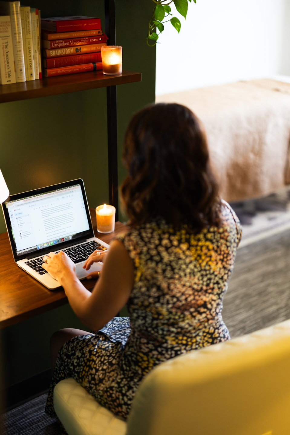 Lesley sitting at her wooden office desk, typing on her computer — Summon Courage therapy in Orange County California