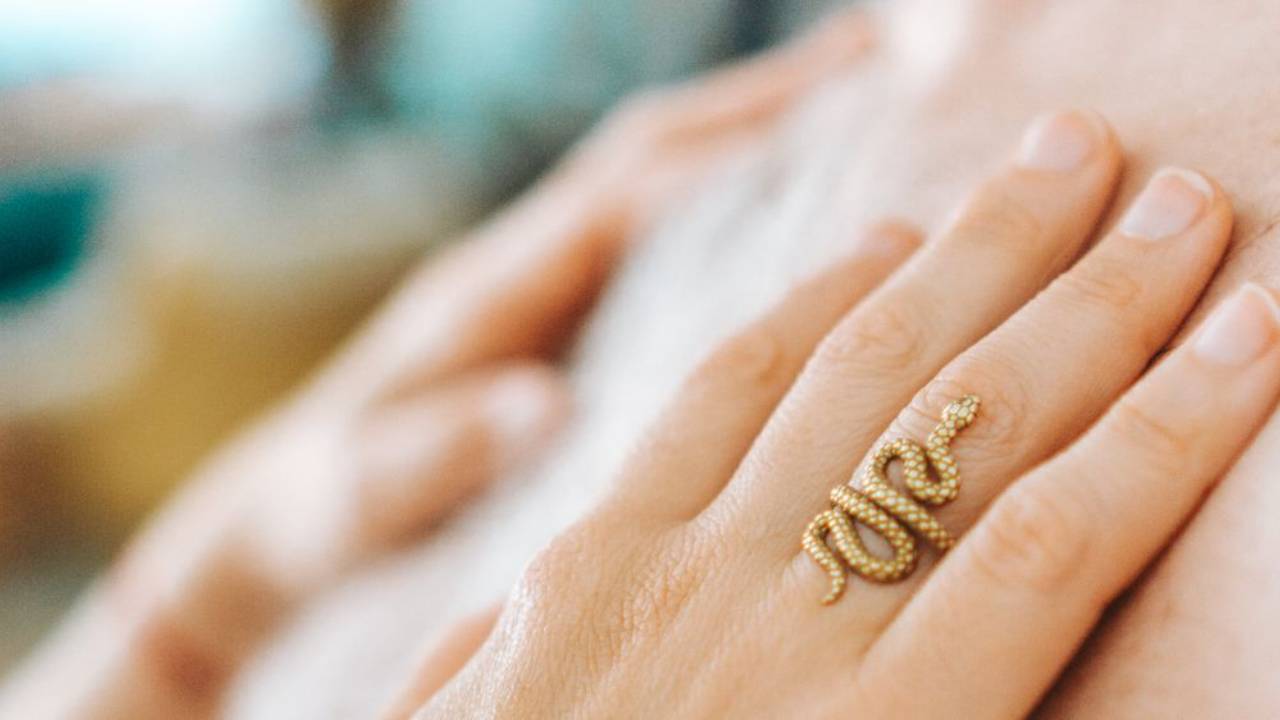 hand on chest with gold ring