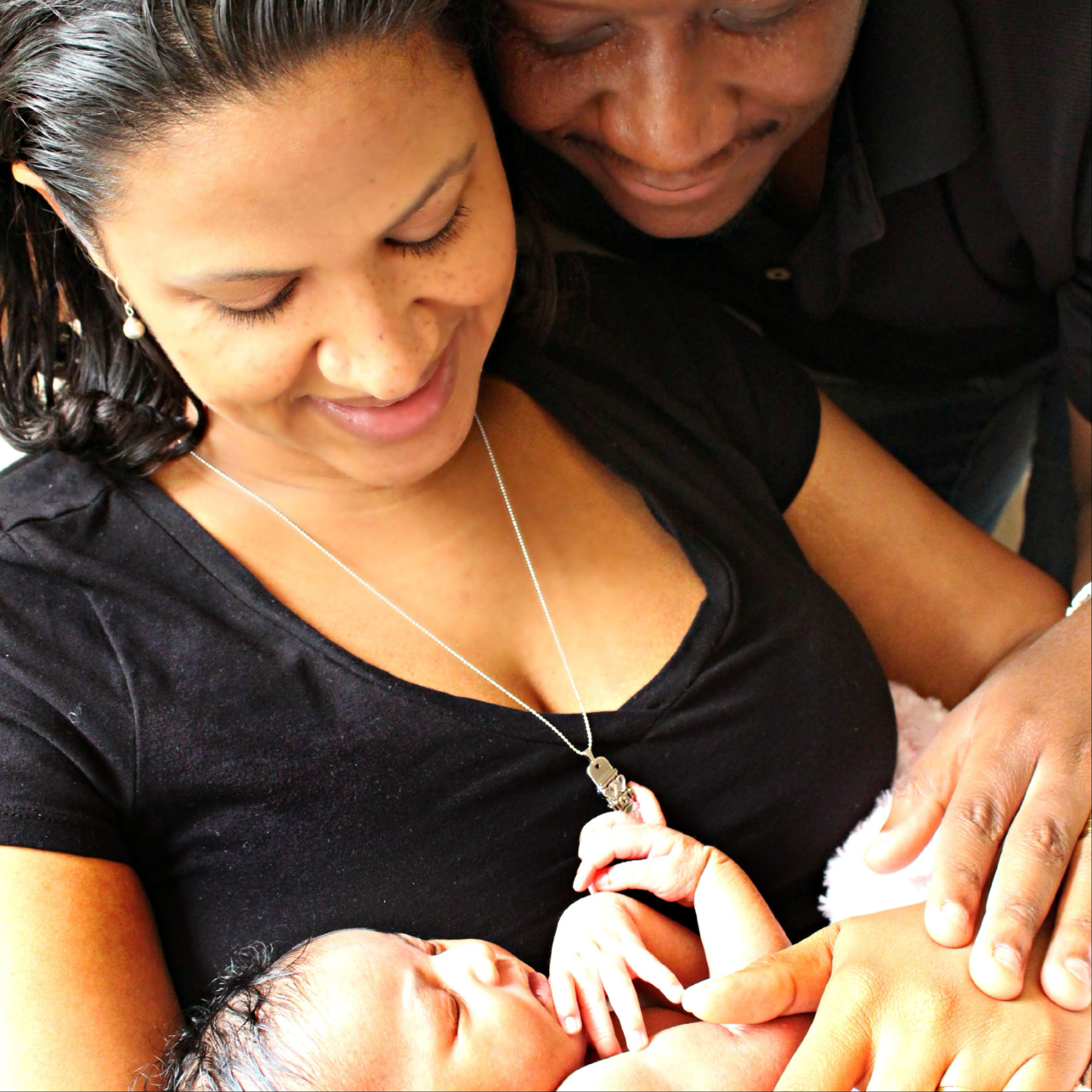 Mother and father holding newborn baby