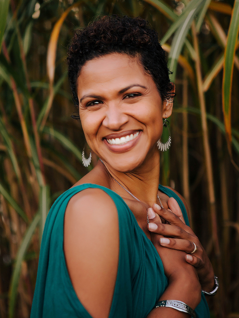 Woman smiling with her hands crossed over her heart