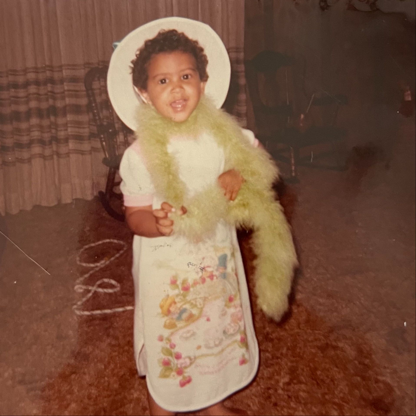 Photo of a toddler playing dress up