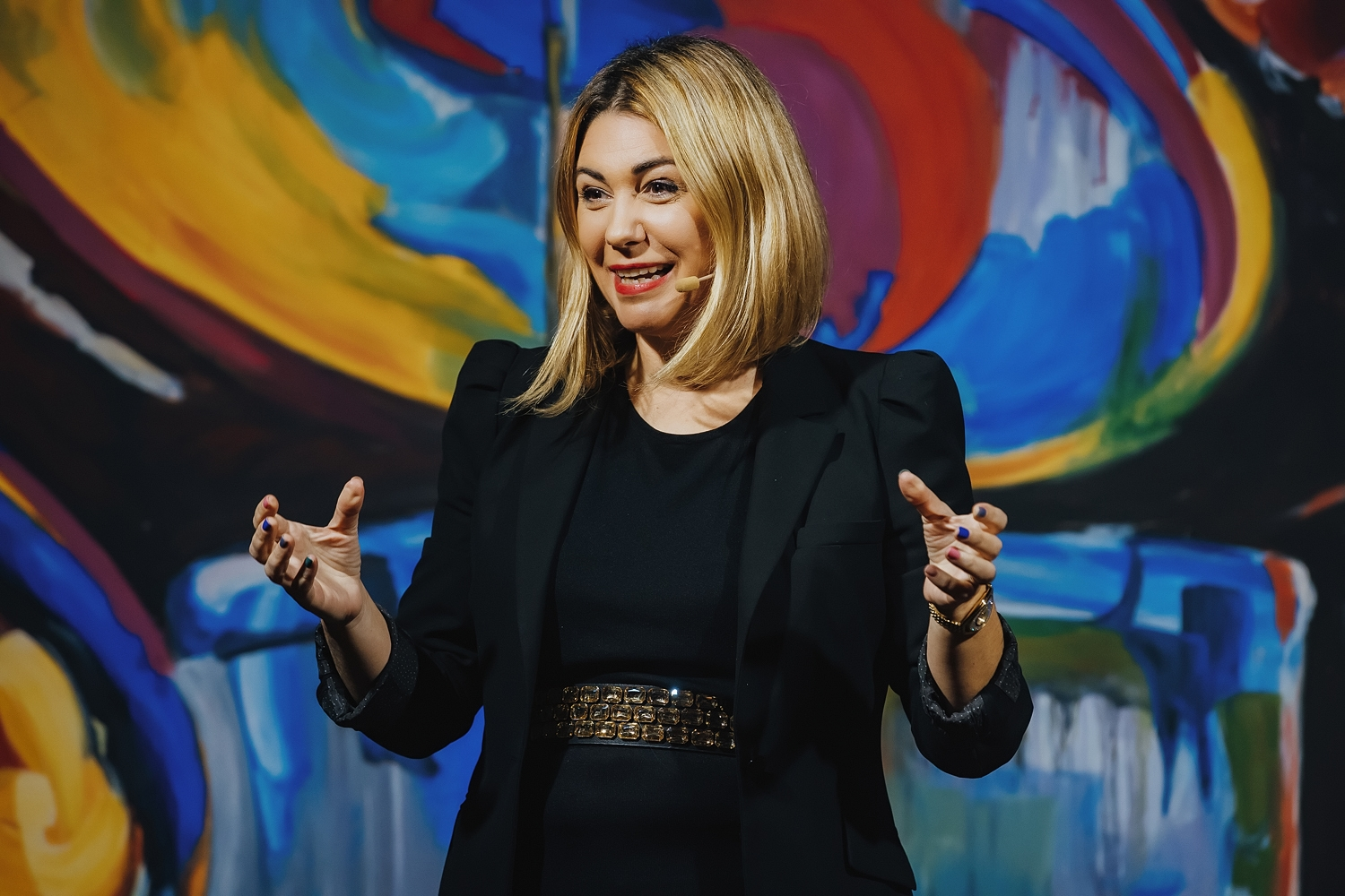 Meta Grošelj gesturing while speaking on stage
