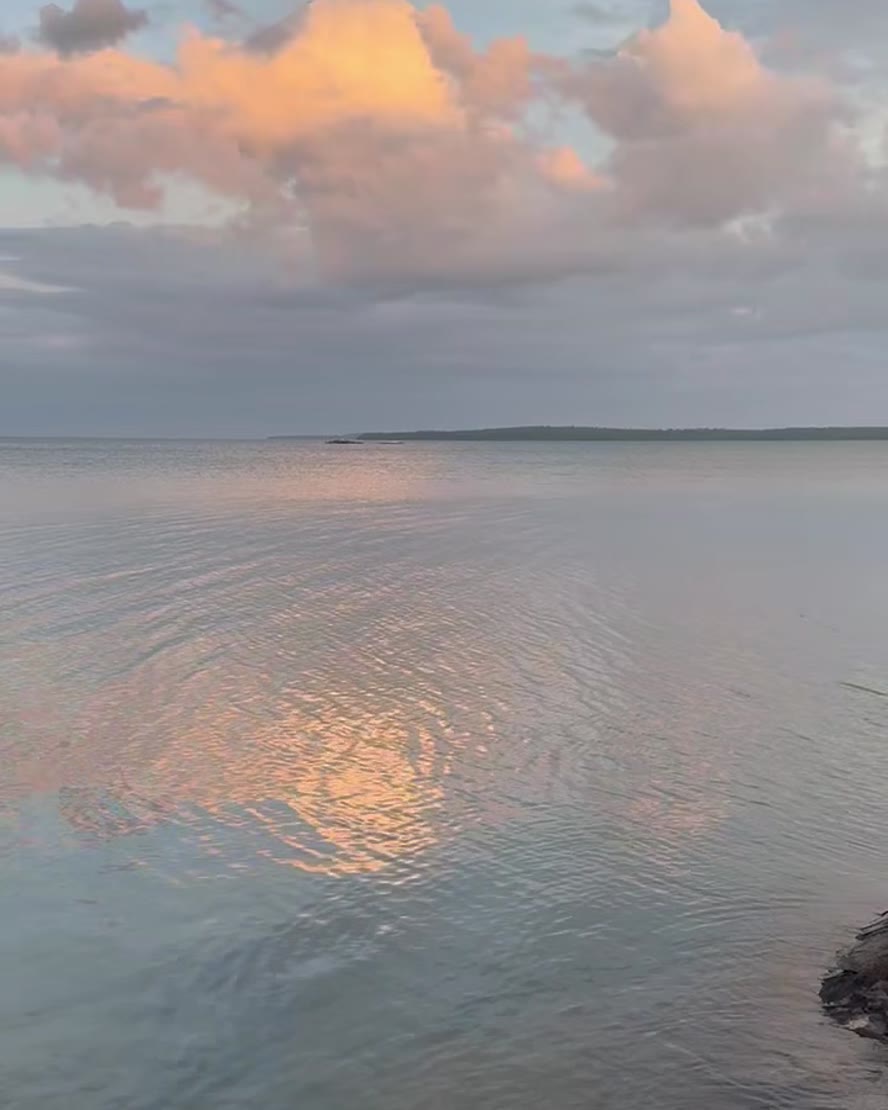 Sunset clouds over calm water