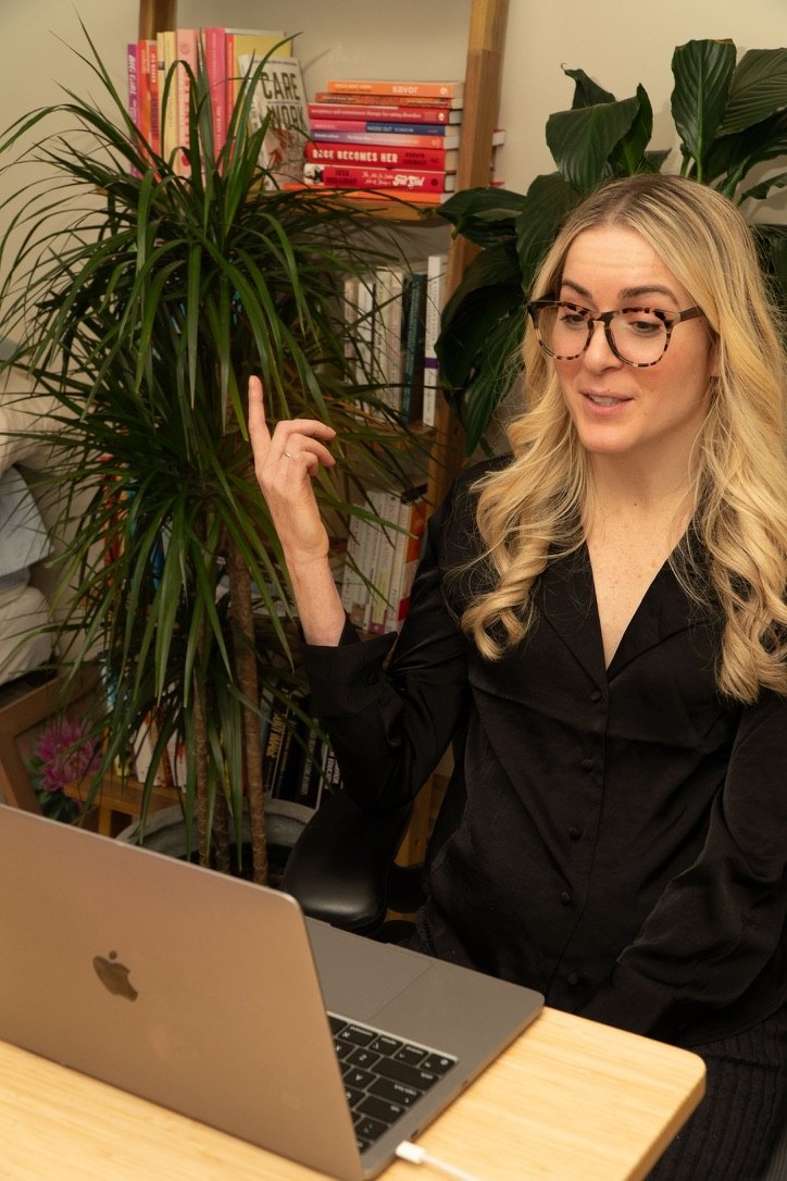 Anna at her desk, mid-conversation on a video call