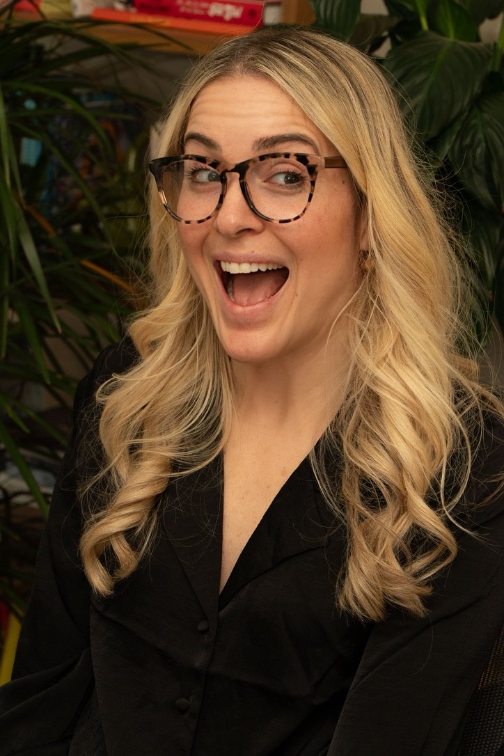 Anna laughing, in tortoiseshell glasses