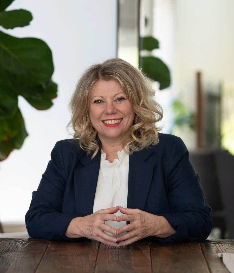 Deb Szabo, AI Business Strategist and Claude Certified Associate, in a navy blazer