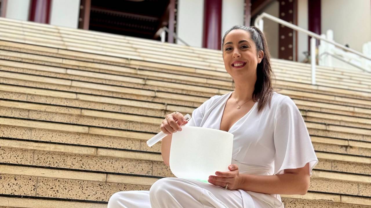 Chakra healing practitioner using crystal singing bowls and tuning forks