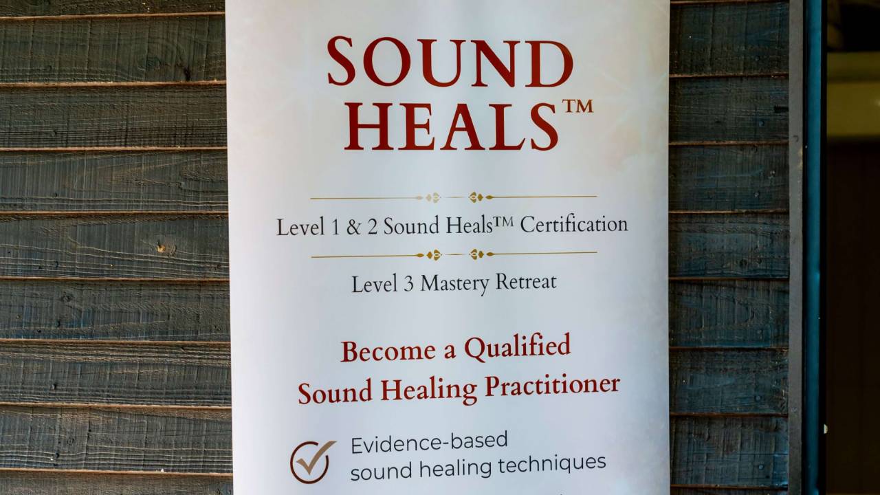Student comparing certificate and accreditation information while researching a sound healing certification course