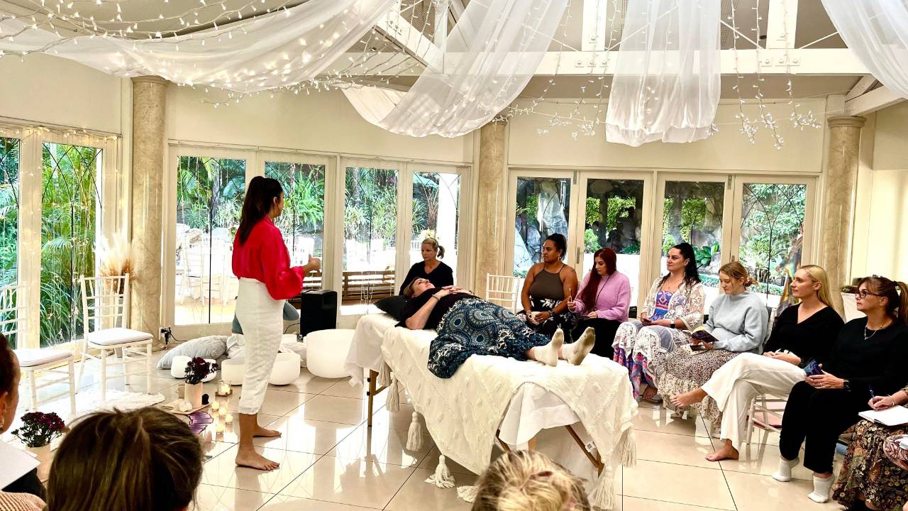 Students learning crystal singing bowls during a professional sound healing certification course.