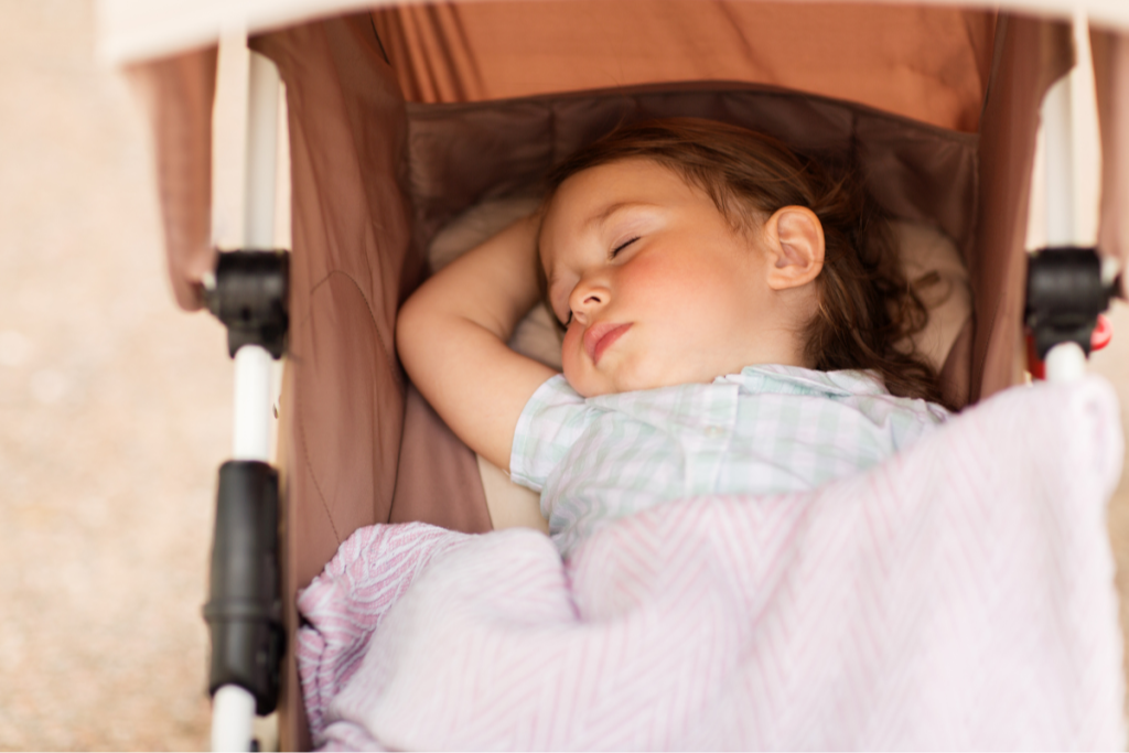 Baby napping peacefully in a stroller while family is out